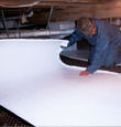 Chugiak insulation being installed in a crawl space.