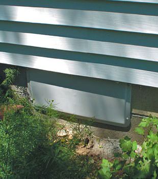A gray crawl space vent cover in Copper Center