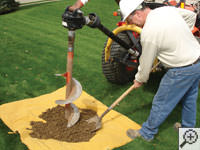Auguring a hole in the earth for a foundation repair in Douglas