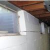 A foundation showing severe inward buckling along the windows in a Talkeetna home.