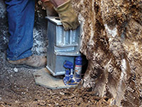 Securing a foundation footing bracket for a foundation repair system in Willow.