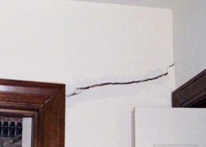 A large drywall crack in an interior wall in Jber