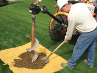 Auguring a hole in the earth for a foundation wall repair system in Big Lake