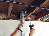 Straightening a foundation wall with the PowerBrace™ i-beam system in a Cordova home.