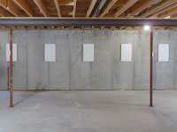 A repaired basement wall with foundation wall anchor covers installed in Valdez.